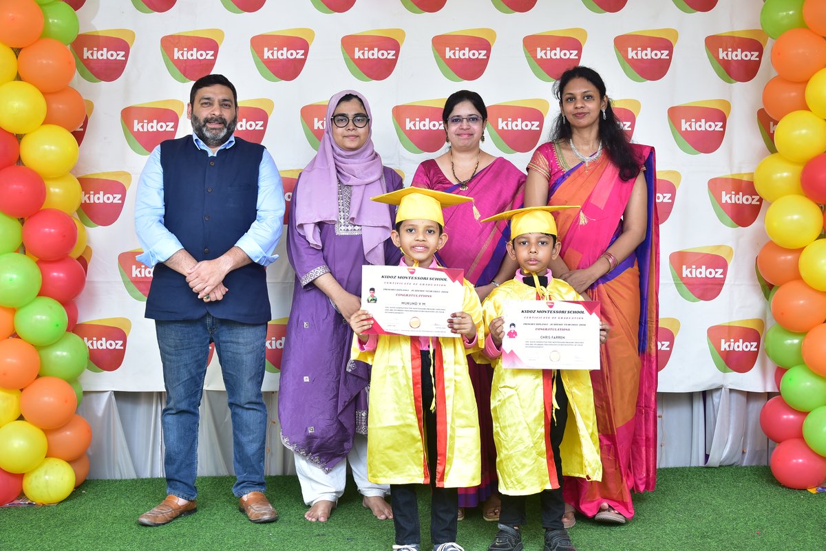 Graduation ceremony — children in caps and gowns with proud parents and teachers