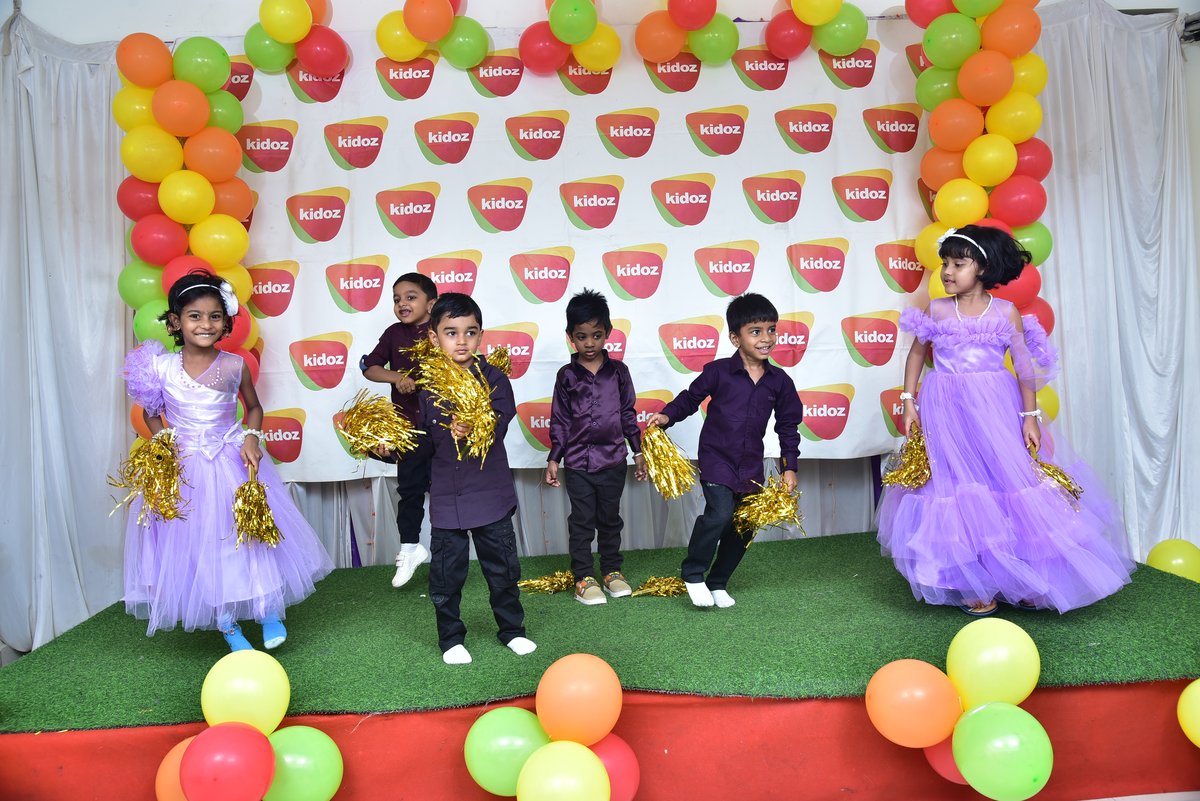 Children dancing with pom-poms at the Kidoz annual celebration