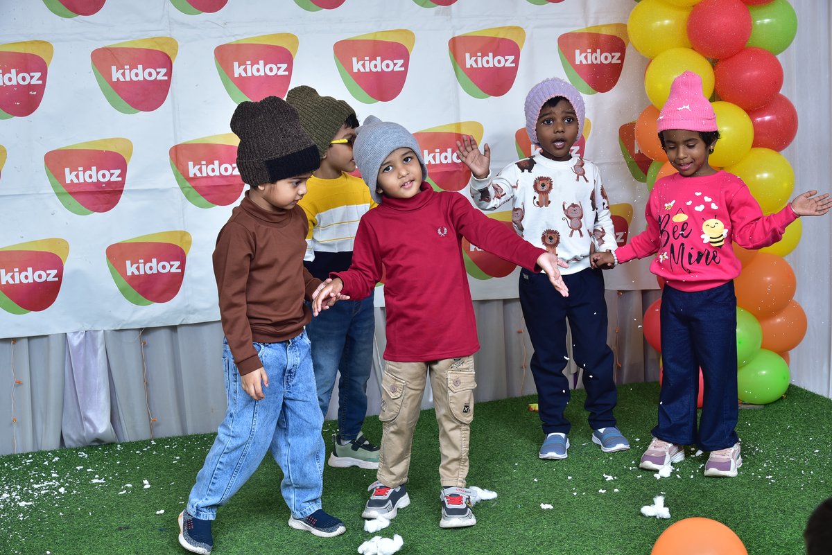 Children dancing and playing during a winter-themed Kidoz event