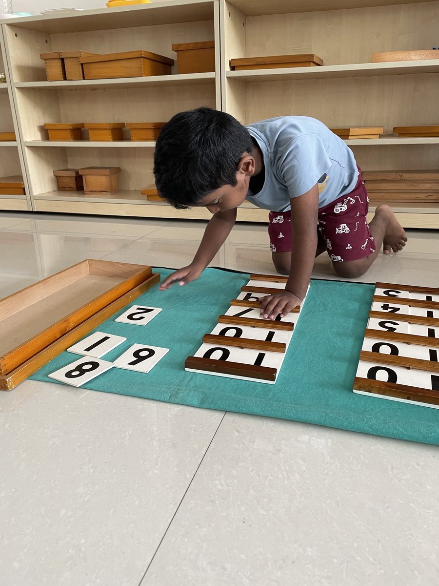 Boy working with number board and math materials